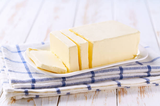 istock Block of fresh butter on a wooden table. 2196247949