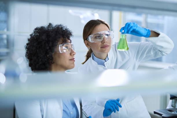 istock Female scientists examining chemical substance in a beaker while working on an experiment. 2196248359