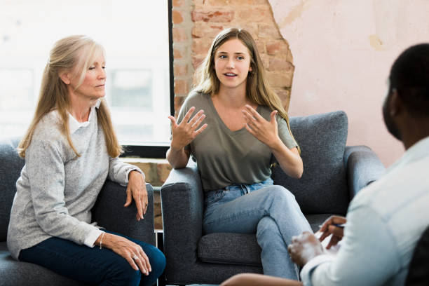 istock Young Woman in Group Therapy Session with Adults 2196253348