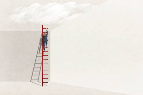 istock Woman Climbing Over Large Wall 2196253946