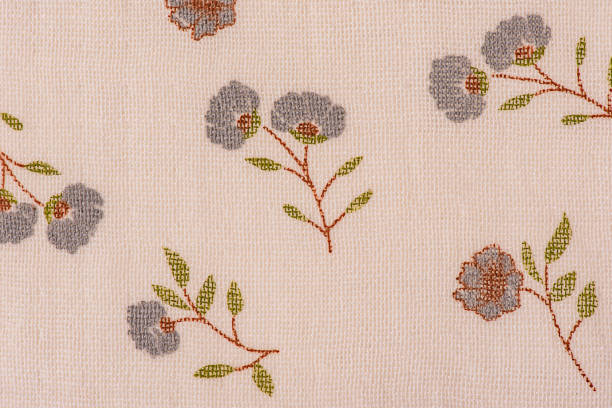 Light beige fabric in a flower as a background macro photo.