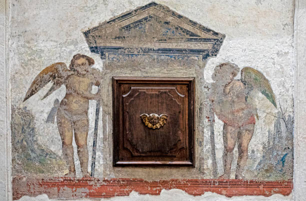 istock wooden hiding place in the wall with two angels 2196258627
