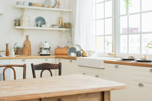 istock Empty white wooden kitchen interior with dining room. Scandinavian classic minimalistic bright kitchen with white and wooden details. Modern white kitchen clean contemporary style interior design. 2196262322
