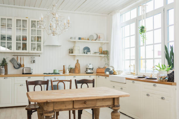 istock Empty white wooden kitchen interior with dining room. Scandinavian classic minimalistic bright kitchen with white and wooden details. Modern white kitchen clean contemporary style interior design. 2196262323