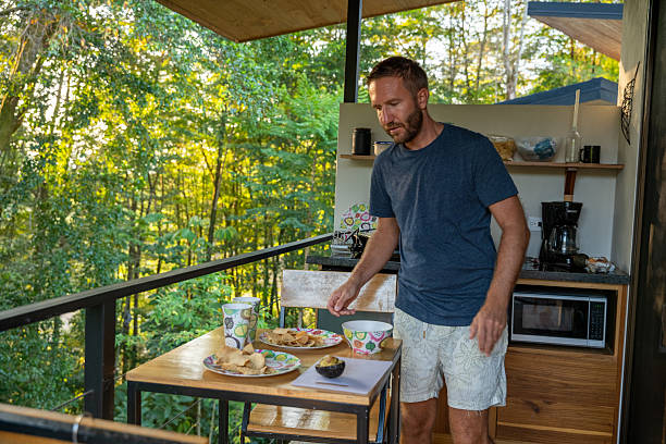 istock Man Preparing Breakfast on Wooded Balcony 2196262614