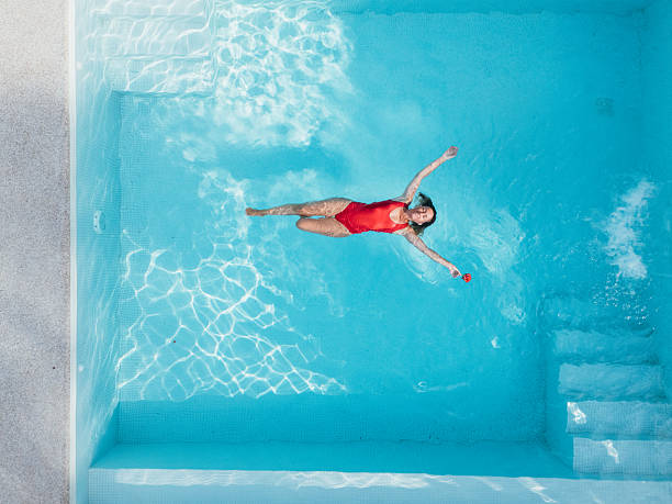 istock Woman Relaxing in a Modern Pool 2196264086