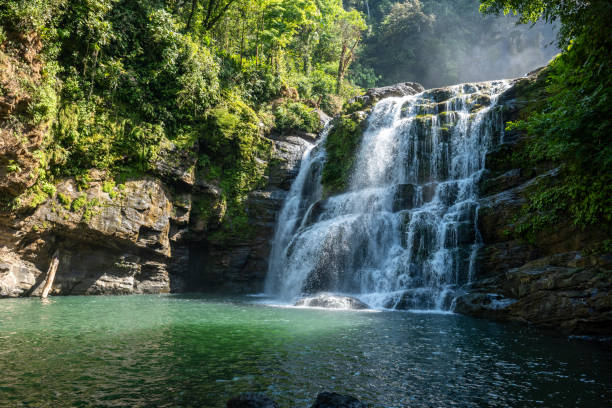 istock Majestic Waterfall Cascading over Lush Cliffside in Tranquil Forest 2196264265