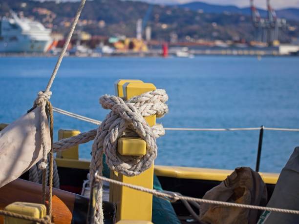 istock Thick rope tied around a steel bollard. 2196265351
