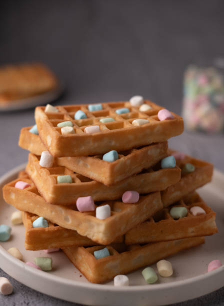istock photo Indulge in a scrumptious stack of golden waffles adorned with vibrant marshmallows, perfect for breakfast or a delightful dessert treat, pleasing both the eye and the palate. 2196268143