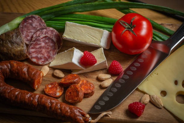 Epicurean Symphony: A Luxurious Still Life of Iberian Jamón, Italian Prosciutto and Artisan Cheeses.Bask in the golden glow of this meticulously composed masterpiece of gastronomic indulgence - a visual ode to Europe's most coveted delicacies, captured in exquisite detail from a painterly top-down perspective.
