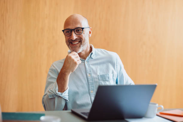 istock Confident Professional Smiling While Working on a Laptop in a Modern Office 2196271016