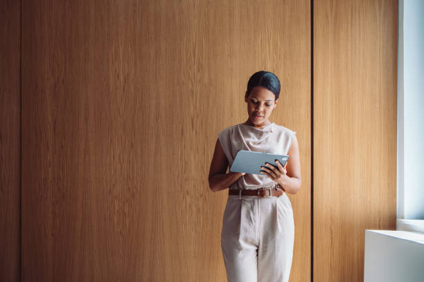 istock Professional Woman Using Digital Tablet in Modern Minimalist Office Setting 2196271022