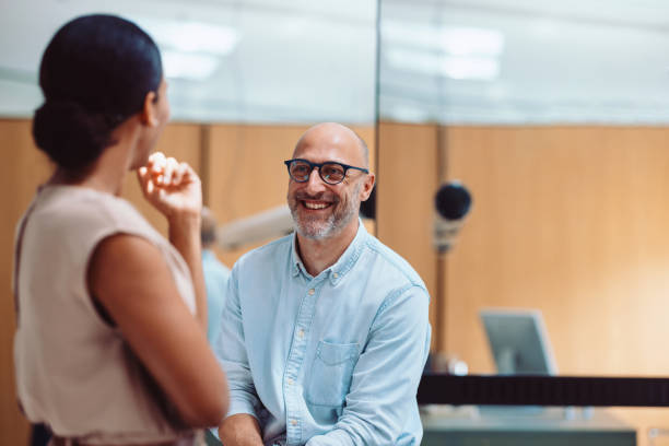 Happy Colleagues Chatting in the Office During a Friendly Interaction