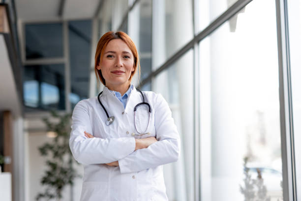 istock Confident Female Doctor in White Coat with Stethoscope in Bright Office 2196274232