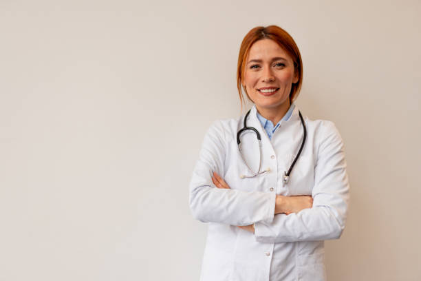 istock Confident Female Doctor Smiling in White Coat with Stethoscope 2196274266
