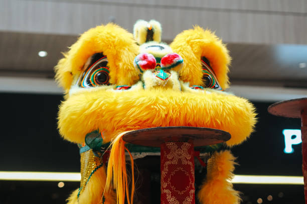 Lion dance surrounded by decorative blossom in temple