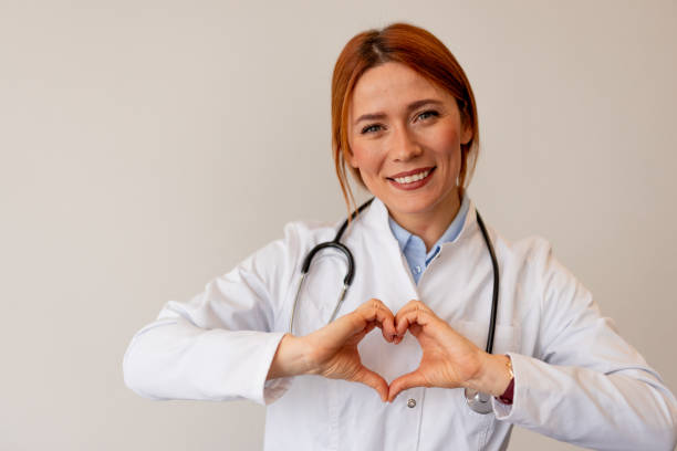 istock Smiling Doctor Holding Heart Shape Symbolizing Care and Compassion 2196274277