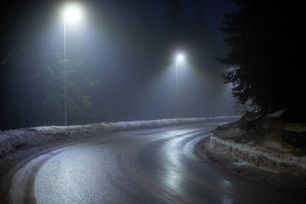 istock Difficult foggy and snowy night time for driving 2196275425