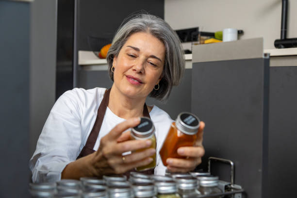 istock Mature woman organizing spice jars in kitchen 2196277322