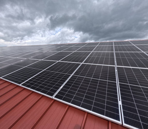 istock Extensive Solar Panel Array on the Metal Roof of a Large Industrial Facility 2196279040