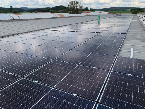 istock Extensive Solar Panel Array on the Metal Roof of a Large Industrial Facility 2196279294