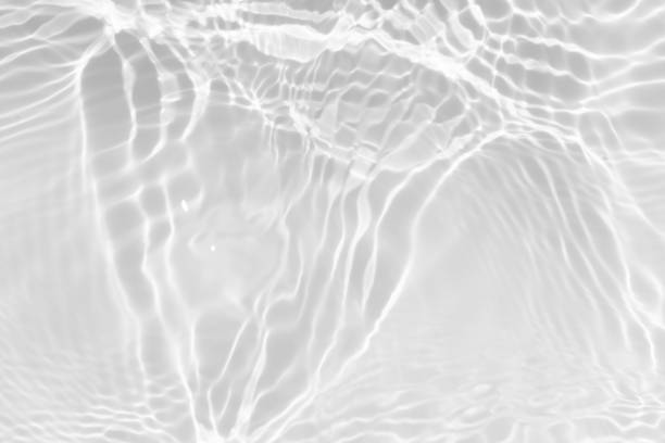 istock White water with ripples on the surface. Defocus blurred transparent blue colored clear calm water surface texture with splashes and bubbles. Water waves with shining pattern texture background. 2196280451
