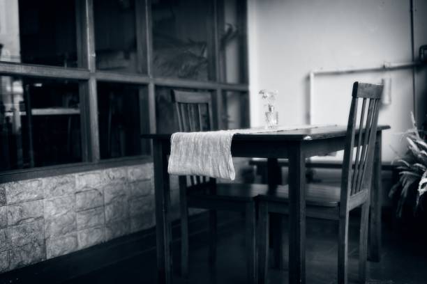 istock Cozy Wooden Table with Flowers in Black and White 2196280501
