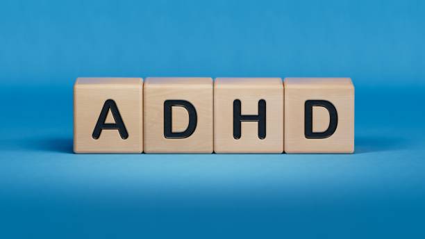 istock Concept of ADHD Attention Deficit Hyperactivity Disorder word on Wooden cube.close up of wooden elements,Business Concept.3D rendering on blue background. 2196283529