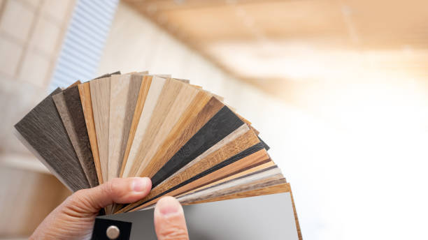 istock Designer hand picking sample of wood laminated material from natural collection. Customer choosing wooden veneer texture or set of MDF board swatch fan for interior finishing or furniture design 2196284468