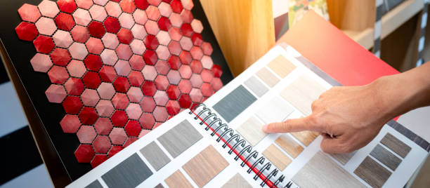 istock Designer hand pointing at wooden laminate swatch collection in material sample catalog. Customer choosing natural wood texture for furniture finishing or interior architecture design. 2196284539