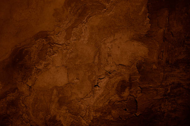 istock Black dark brown orange concrete wall surface. Grunge texture background. Close-up. Paint. Crack old rough broken damaged crumbled creepy. Dark light. Building facade exterior. 2196284630