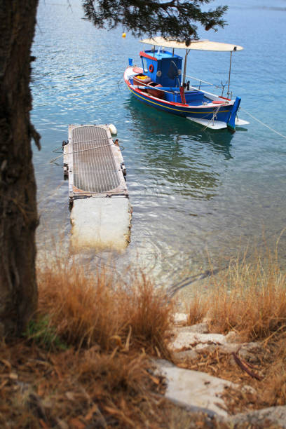 Pier with traditional wooden fishing boat, Ithaki island, Ionian Sea, Greece