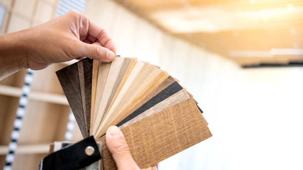 istock Designer hand picking sample of wood laminated material from natural collection. Customer choosing wooden veneer texture or set of MDF board swatch fan for interior finishing or furniture design 2196284797
