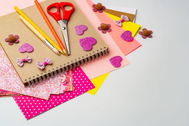 istock Crafting materials on a table showcasing colorful paper, scissors, and decorative embellishments for creative projects 2196289836