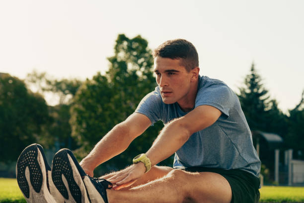 istock Young athlete stretching on a sunny day in a park to prepare for a training session 2196289840