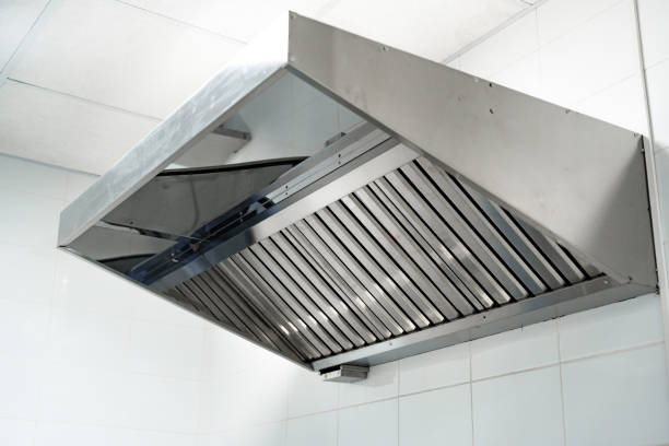 Stainless steel kitchen exhaust hood in modern restaurant kitchen for effective ventilation and smoke removal