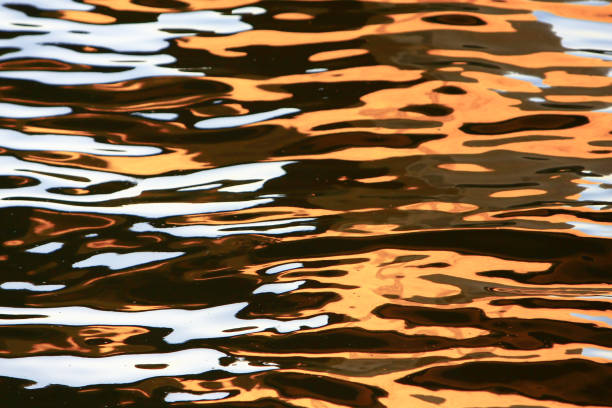 istock 24 July 2008 the Golden water waves at sun set 2196291034