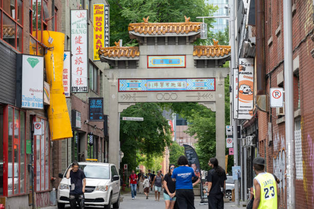 Montreal, Canada - July 5, 2024. People on street at entrance gate to Chinatown, Montreal, Quebec, Canada