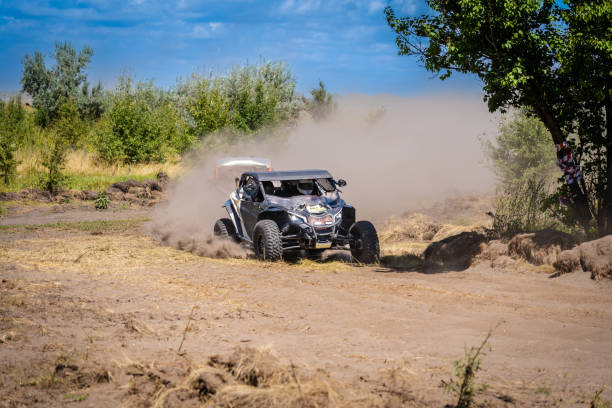 Extreme road conditions, difficult track for off-road vehicles, attempt to drive over a large obstacle with water, mud and sand on the track of an off-road car race