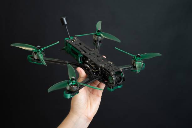 istock Professional modern drone with digital camera in hand on black background 2196294216