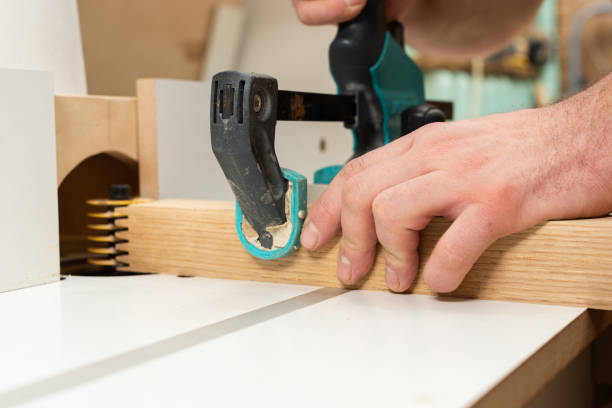 istock The carpenter is milling an oak part using a clamp 2196294587