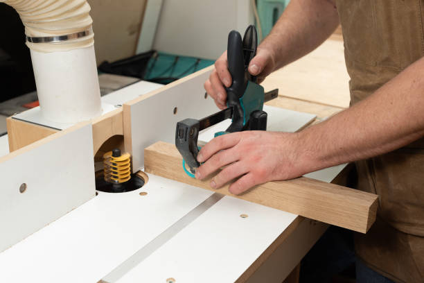 istock The carpenter is going to mill an oak part using a clamp and a special stop 2196294589