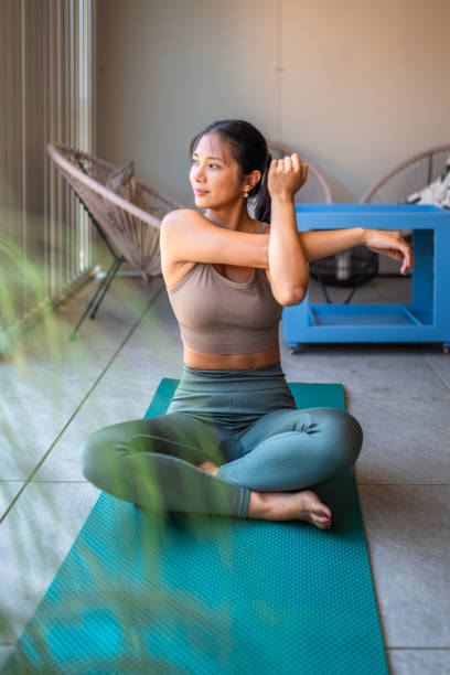 istock Asian Woman Practicing Yoga on Home Balcony 2196294750