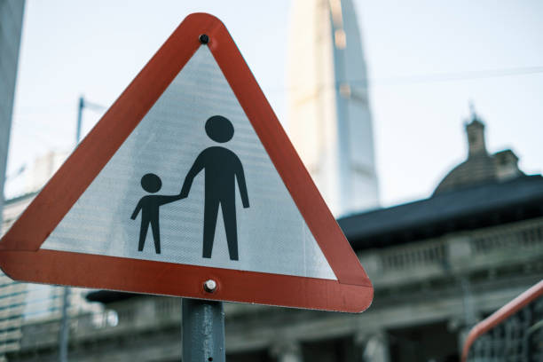 istock Caution sign for pedestrian safety featuring child and adult 2196295669
