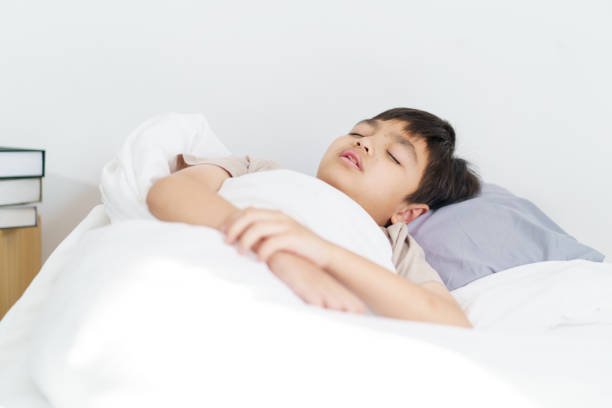 istock Asian little boy wakes up in morning. 2196297178
