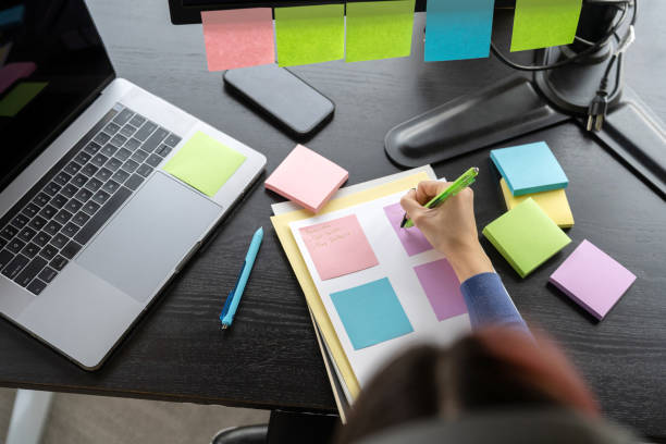 istock Young woman working in the office taking notes 2196306937