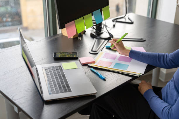 istock Young woman working in the office taking notes 2196306939