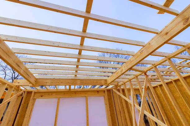 istock Construction of a wooden structure with exposed beams during a clear day in an open area 2196307688