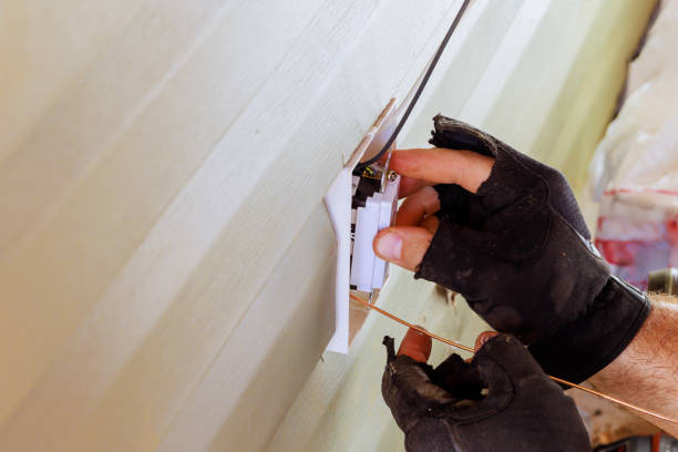 istock Connecting electrical outlets installing sockets on a exterior facade of house is responsibility of an electrician 2196308472