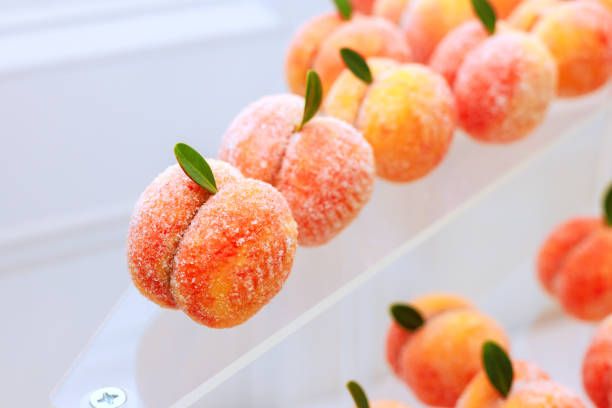 istock Delicious peach shaped confections displayed attractively dessert showcase during celebratory event. 2196308511